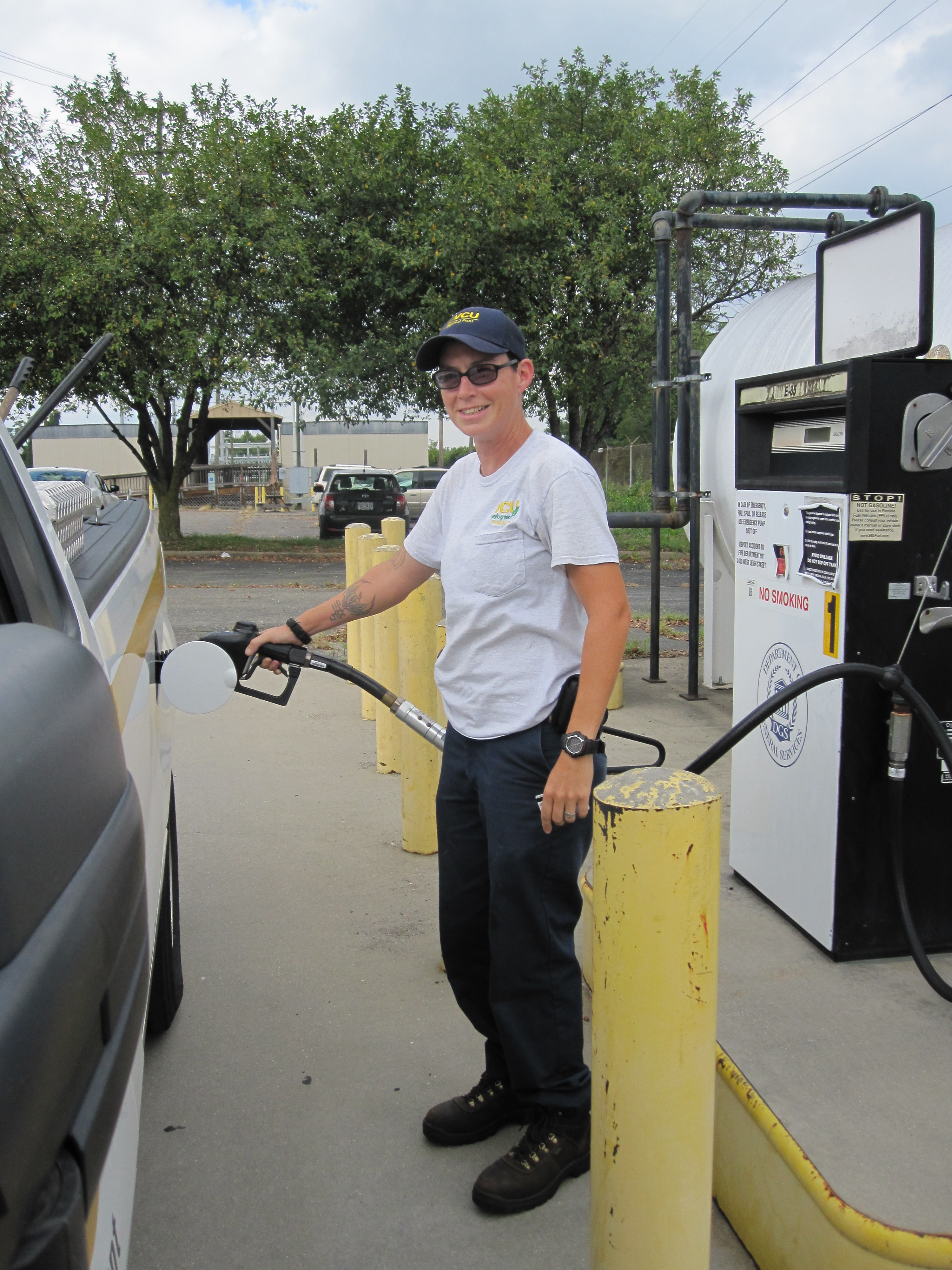 VCU employee pumping gas at Department of General Services Fuel Site