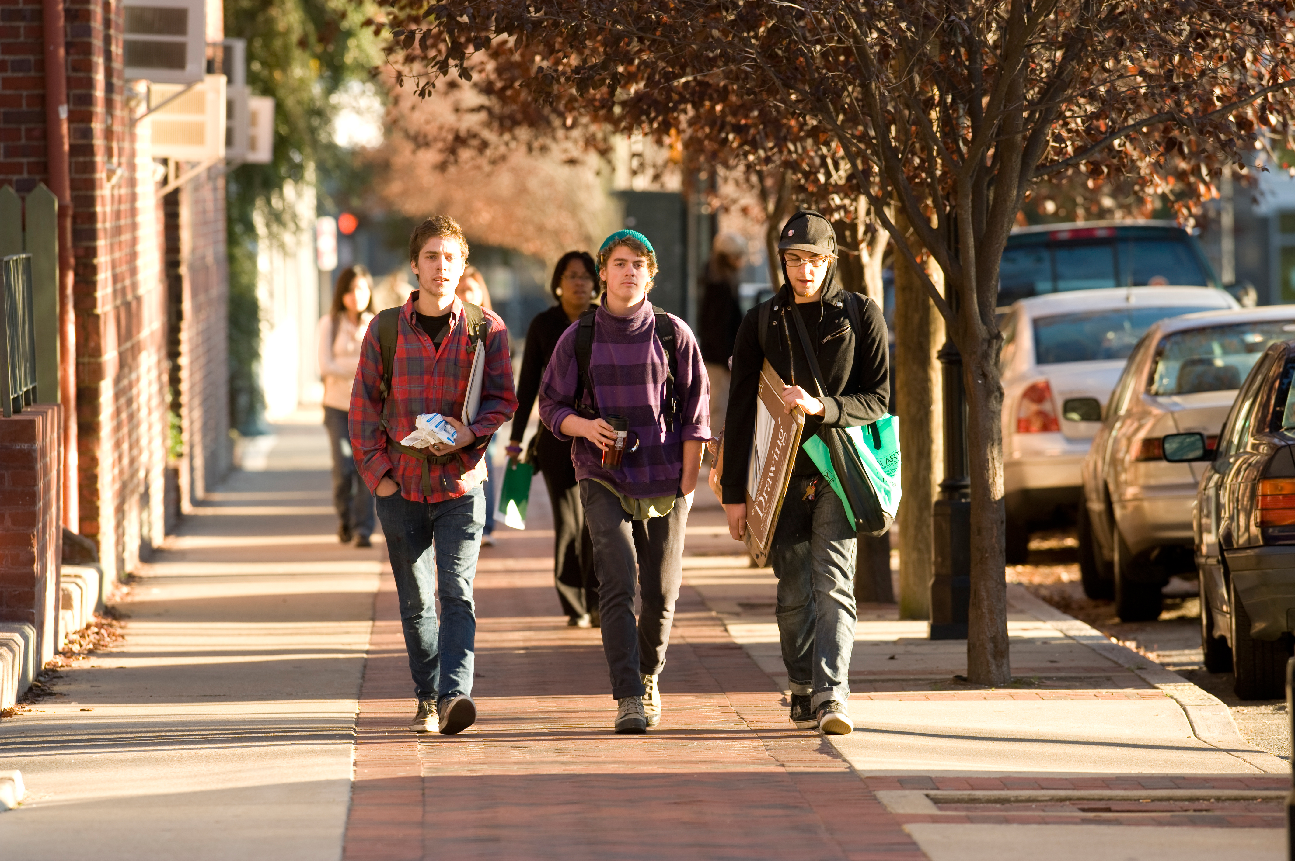 Three Students walking down a street on VCU's campus