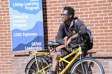 student with RamBikes bike