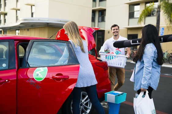students loading a Zipcar on campus