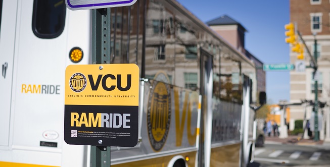 RamRide bus stop sign with RamRide bus beside it